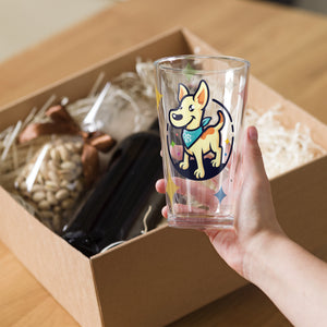 Hand holding a clear glass with a dog illustration above an open box containing snacks.